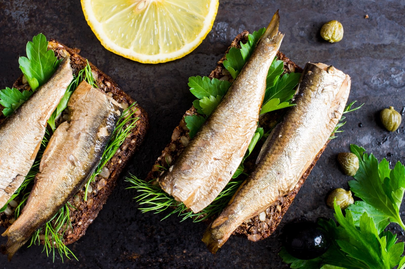 Sandwich with sardines, sprats with parsley and dill